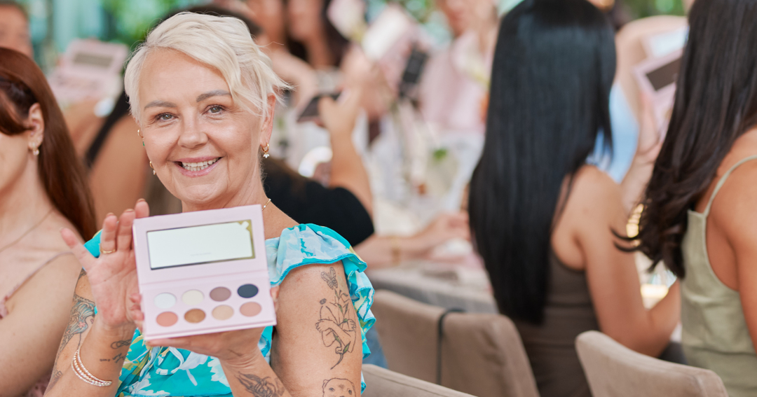 Women with eyeshadow palette in blue dress
