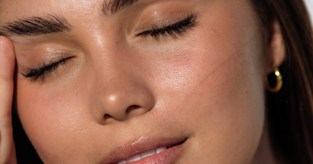 Woman with eyes shut and hand on face