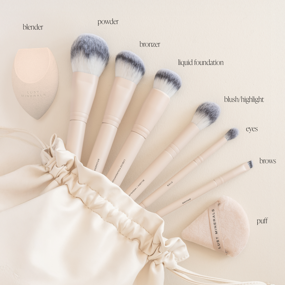Set of makeup brushes with labels on a beige background