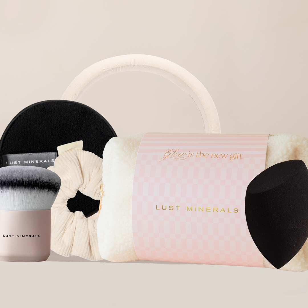 Makeup brushes and a pink pouch with 'Lust Minerals' branding on a light background