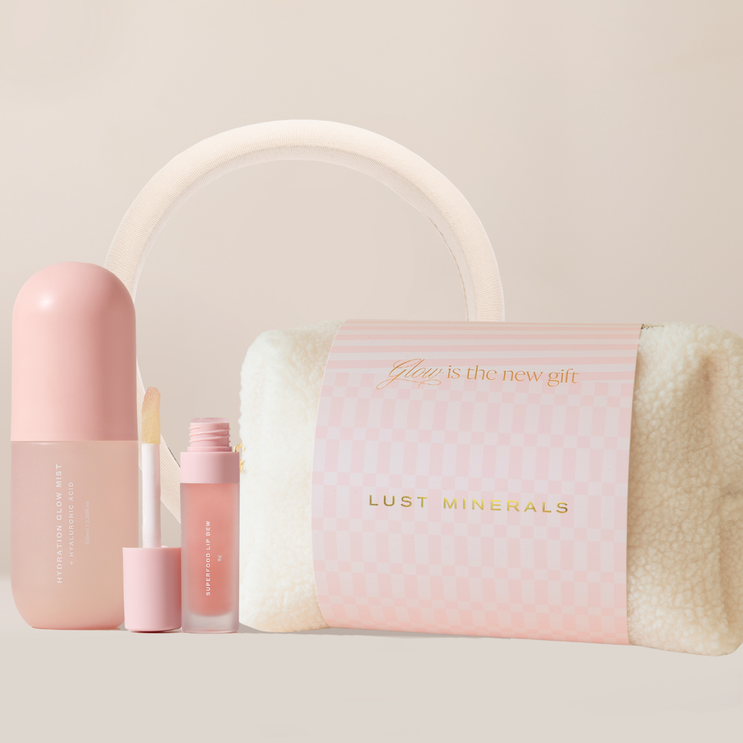Pink skincare products and pouch with 'Lust Minerals' branding on a light background