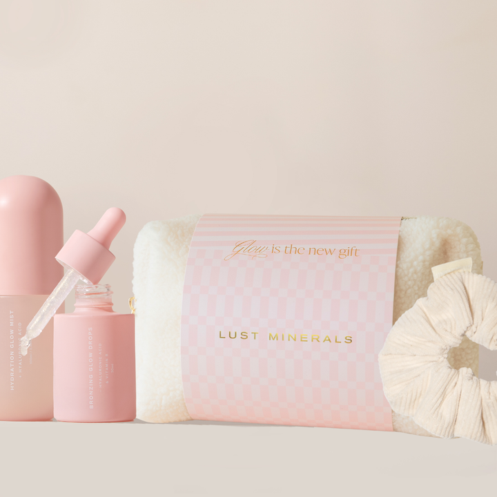 Pink skincare product with dropper and 'Lust Minerals' packaging on a light background