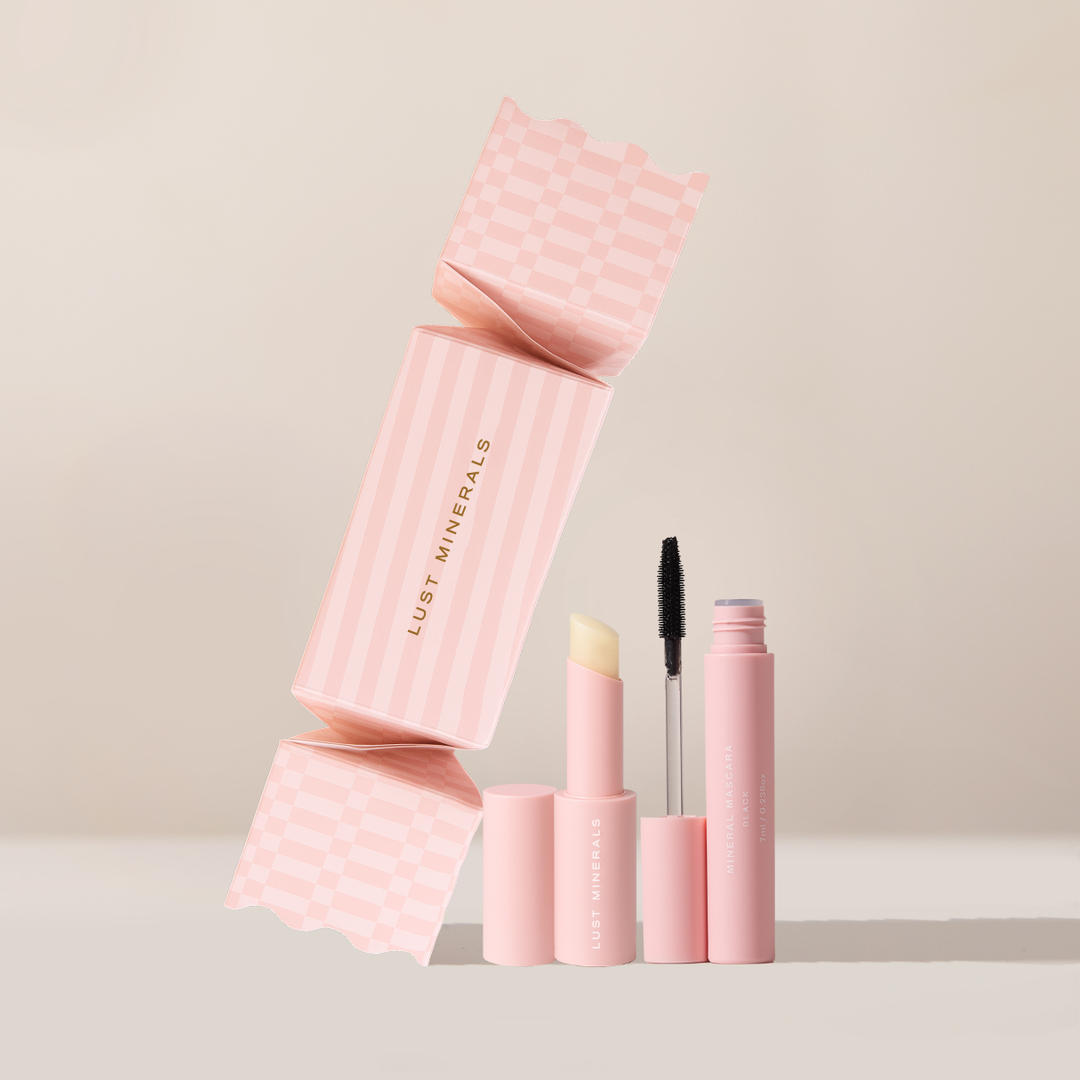 Pink makeup products with 'Lust Minerals' branding on a beige background