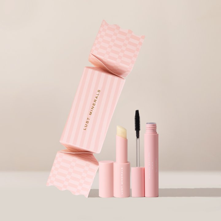 Pink makeup products with 'Lust Minerals' branding on a beige background