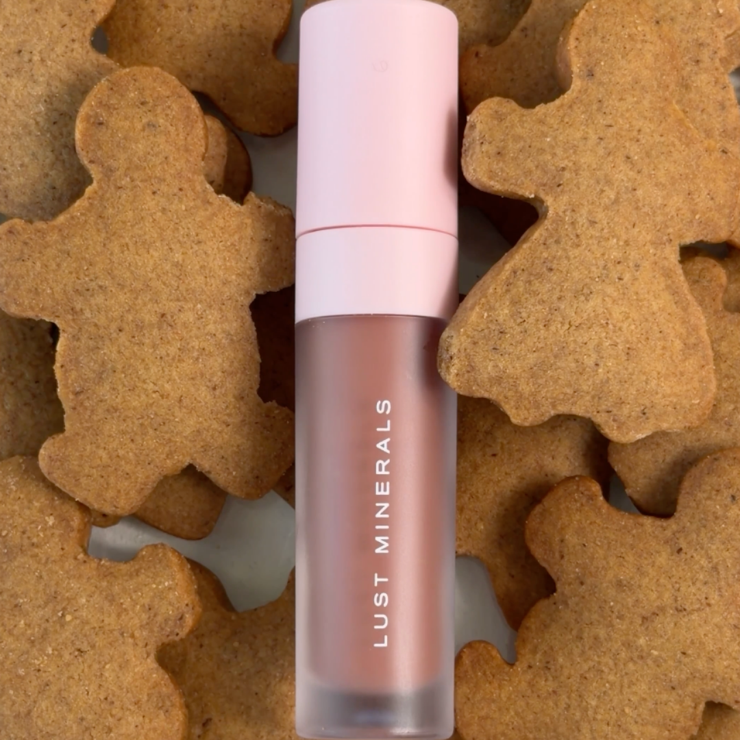 Lip gloss on a background of gingerbread cookies.